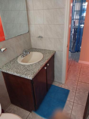 a bathroom with a sink and a toilet at LRM Home in Basseterre