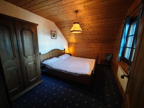a bedroom with a bed in a wooden room at Nassfeld Sonnleitn by Semi in Hermagor