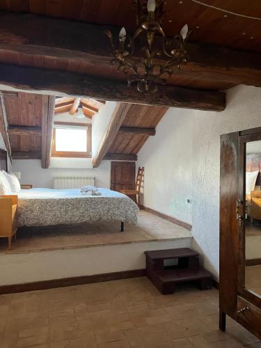 a bedroom with a bed in a room with wooden ceilings at Santocasale in Rocca di Mezzo