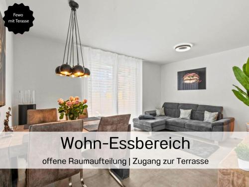 an image of a living room with a couch and a table at Ferienhausträume - ebenerdiges Bodensee Apartment mit Garten und großer Terrasse mit Grill in Kreuzlingen