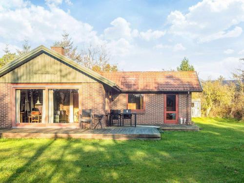 a brick house with a patio in the yard at Secluded Retreat in Blavand - By Traum Ferienwohnungen in Blåvand