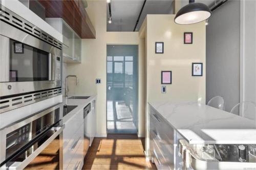 a kitchen with white counters and a large appliance at Downtown one bedroom apartment 2 in Victoria