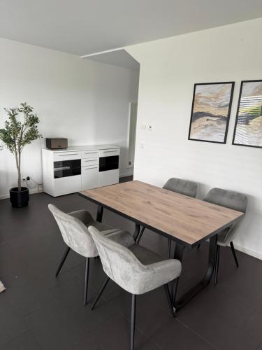 a dining room with a wooden table and chairs at Luxuswohnung direkt am Phönixsee in Dortmund