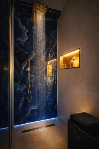 a bathroom with a shower with a shower head at Love Room 85 avec Jacuzzi & Terrasse Privé in Kortrijk