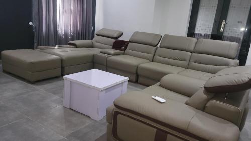 a living room with a couch and couches at Lakatabu Apartments in Mama