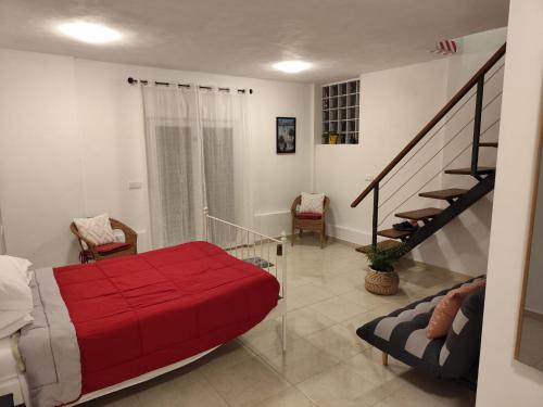 a bedroom with a red bed and a staircase at Vivienda LorenNani in El Paso