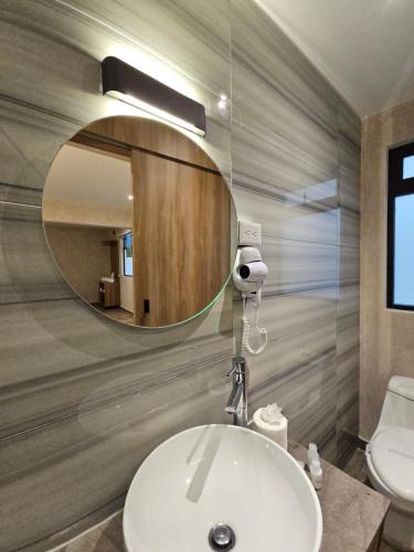 a bathroom with a white sink and a mirror at Hotel Único La Villa in Mexico City
