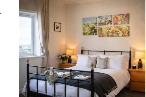 a bedroom with a bed and a window at Royal Mile Famous Canongate Flat in Edinburgh