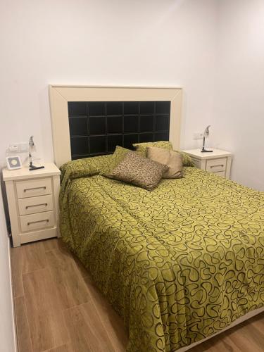 a bedroom with a large bed and two night stands at Finca Rural Marmito in Sanlúcar de Barrameda