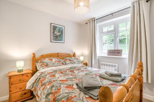 a bedroom with a wooden bed and a window at 2 Bed in Peterstow oc-w33537 in Peterstow