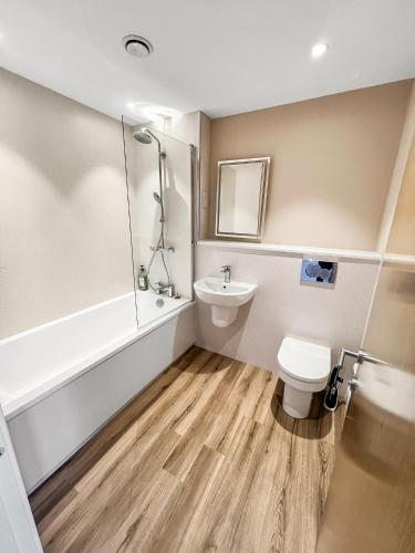 a bathroom with a toilet and a sink at Flat 1 - Luxury Bolton City Centre Apartments in Bolton