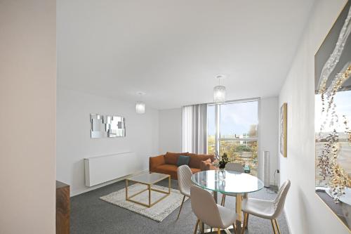 a living room with a table and a couch at Hub Retreat in Milton Keynes