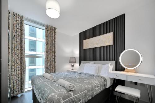 a bedroom with a bed with a large window at Hub Retreat in Milton Keynes