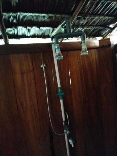 a pipe is attached to a wooden wall at Bruno Raja Ampat Homestay in Pulau Mansuar
