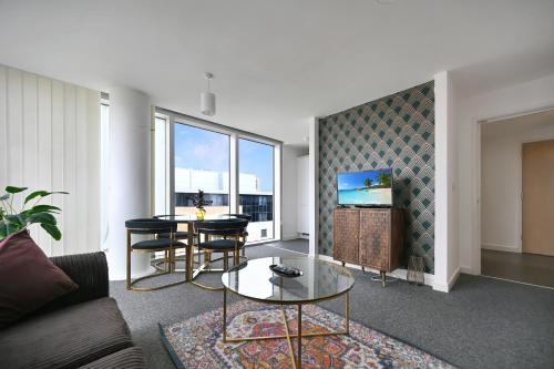 a living room with a couch and a table at Hub Retreat in Milton Keynes