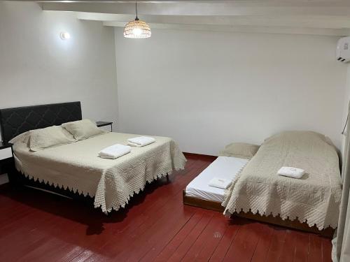 a room with two beds with towels on them at Eucalipto Dúplex in San Vicente