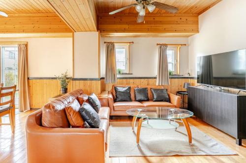 a living room with a couch and a table at Hakuba Powder Cottage in Hakuba