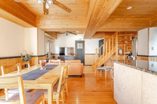 a kitchen and dining room with a table and chairs at Hakuba Powder Cottage in Hakuba