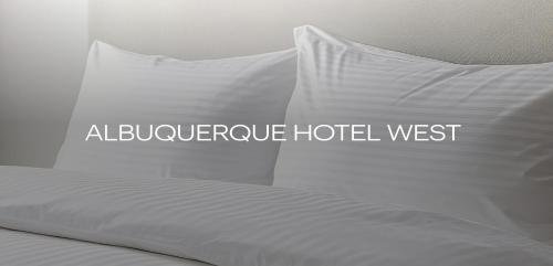 a bed with white sheets and pillows with the words appliance hotelwest at Albuquerque Hotel West by IHG in Albuquerque