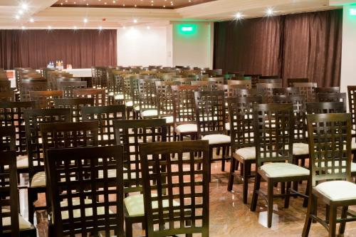 a room with rows of chairs in a conference room at Hotel Yesterday in Bucharest