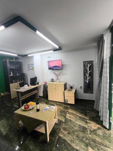 an office with a desk and a table in a room at Emerald DesignHome near metro, tram, 10' Acropolis in Athens