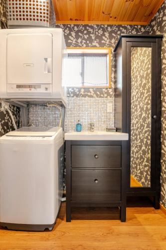 a small kitchen with a sink and a refrigerator at Hakuba Powder Cottage in Hakuba