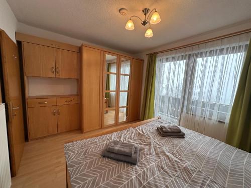 a bedroom with a bed and a large window at Haus Ernestine in Sankt Urban