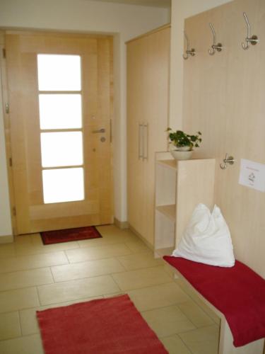 a bathroom with a red bench and a window at Erblehenhof in Forstau