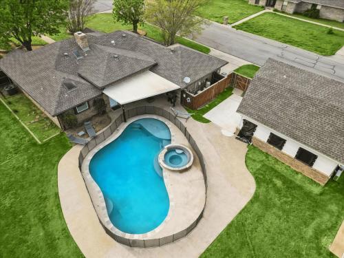 an overhead view of a swimming pool in the backyard of a house at Gorgeous 4BR Home with Huge Yard Pool in Denton