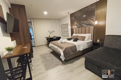 a bedroom with a bed and a table and a desk at Epic Suite 511 Premium Airport in Pereira