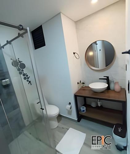 a bathroom with a shower and a sink and a mirror at Epic Suite 511 Premium Airport in Pereira