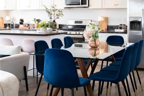 a kitchen with a dining table and blue chairs at 5 Star Private House 5 rooms in Los Angeles