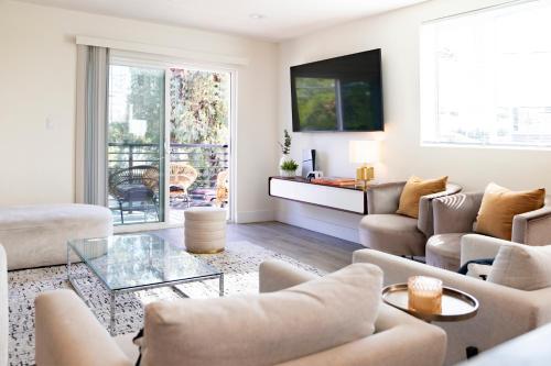 a living room with a couch and a table at 5 Star Private House 5 rooms in Los Angeles