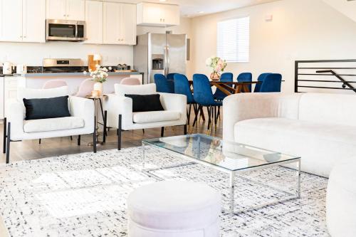 a living room with white furniture and blue chairs at 5 Star Private House 5 rooms in Los Angeles