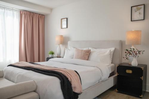 a bedroom with a large white bed and a window at 5 Star Private House 5 rooms in Los Angeles