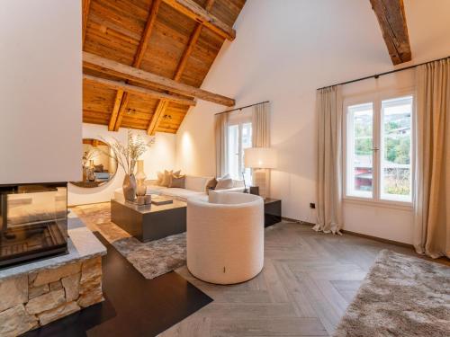 a living room with a couch and a fireplace at Villa Filzer in Kirchberg in Tirol
