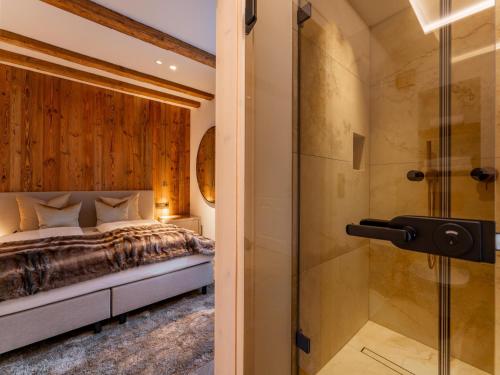 a bedroom with a bed and a shower at Villa Filzer in Kirchberg in Tirol