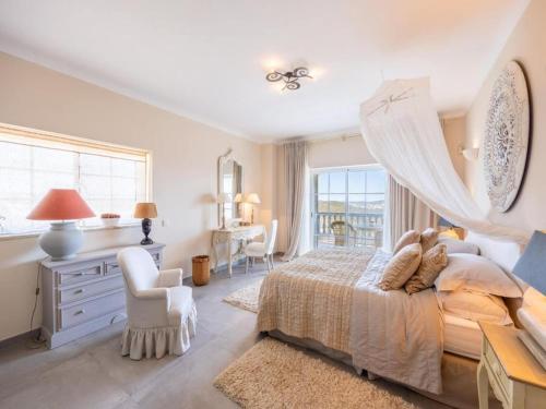 a white bedroom with a bed and a window at Private Bedroom in a Luxurious Villa, Budens in Budens