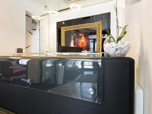 a living room with a tv and a fireplace at Nova City Garni Hotel Signature Collection in Belgrade