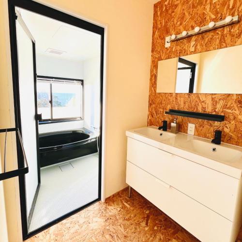a bathroom with a mirror and a sink at Agri Museum NADA - Vacation STAY 40517v in Minamiawaji