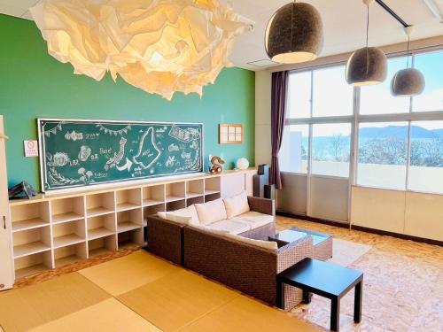 a living room with a couch and a chandelier at Agri Museum NADA - Vacation STAY 40517v in Minamiawaji
