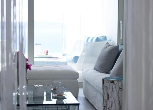 a living room with a white couch and a table at Proteas Blu Resort in Pythagoreio