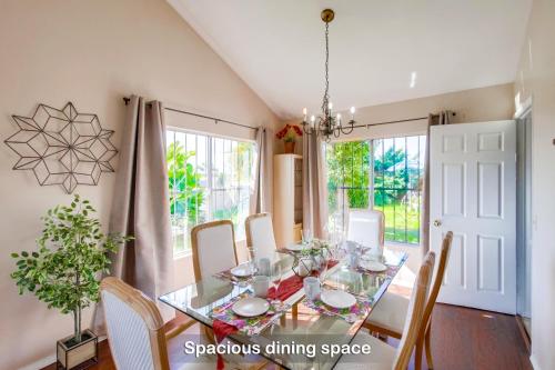 a dining room with a glass table and chairs at Entire Private Home with 4 Bedrooms - 3 Bathrooms, Big Yard, Garage, King Bed, Crib, Available Now in San Diego