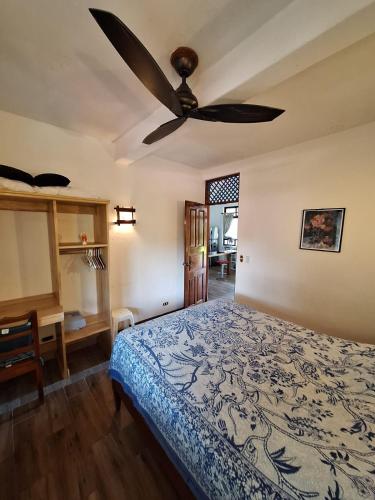 a bedroom with a bed and a ceiling fan at noemi apartments samara beach A-2 in Sámara