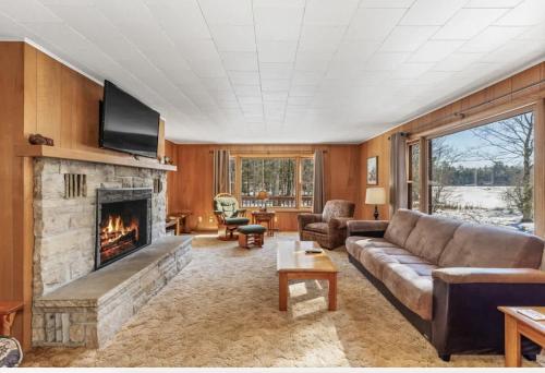 a living room with a couch and a fireplace at Eagle Villa At Otter Cove in Eagle River