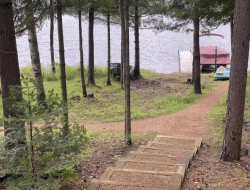 a dirt road next to a lake with a tent at Eagle Villa At Otter Cove in Eagle River