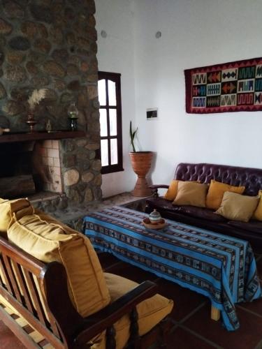 a living room with a couch and a table at Habitaciones La Apacheta - El Mollar in Tafí del Valle