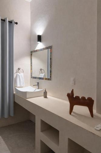 a bathroom with a sink and a mirror at Chulel Hotel Origen in Cedro