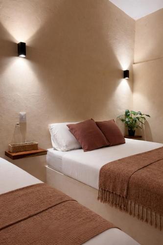 a hotel room with two beds in a room at Chulel Hotel Origen in Cedro