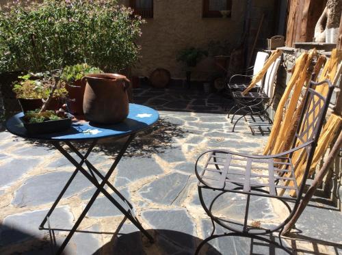 a table and chairs on a stone patio at Casa Rural Era de Ferro in Erill la Vall